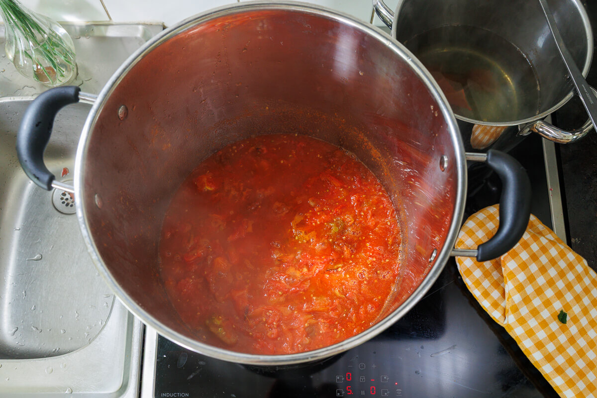 Färdigrostad tomatsås kokas ner i en stor kastrull